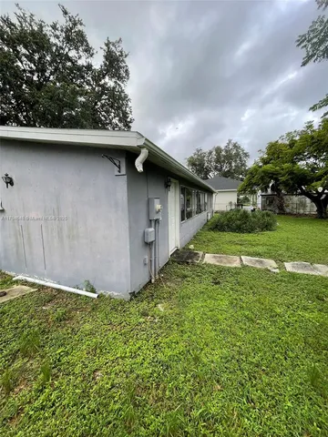 a view of backyard with large trees