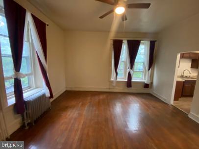6314 Musgrave Street, Unit 4 Philadelphia, PA 19144 - Photo 1 of 10 a view of an empty room with wooden floor and a window