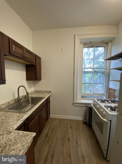 6314 Musgrave Street, Unit 4 Philadelphia, PA 19144 - Photo 2 of 10 a kitchen with granite countertop a sink a stove and cabinets