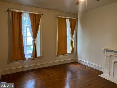 6314 Musgrave Street, Unit 4 Philadelphia, PA 19144 - Photo 6 of 10 an empty room with wooden floor and windows