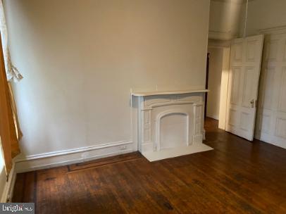 6314 Musgrave Street, Unit 4 Philadelphia, PA 19144 - Photo 7 of 10 a view of empty room with wooden floor and fan