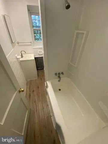 a bath tub sitting next to a bathroom sink