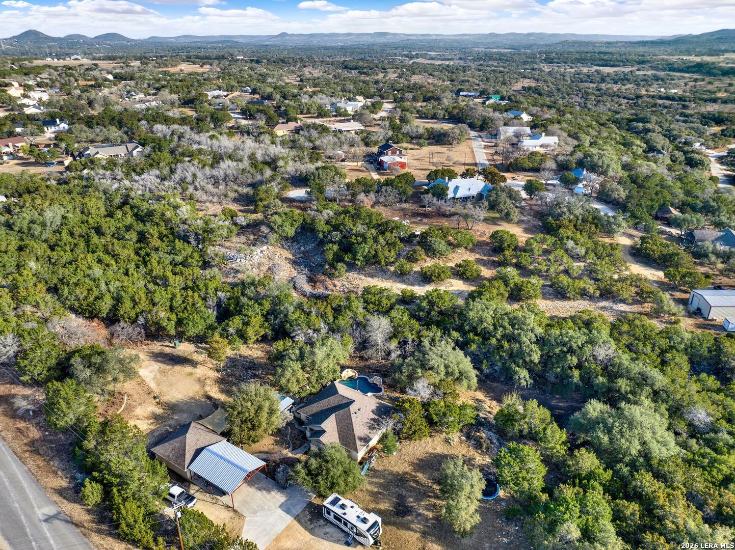 145 Elm Drive Bandera, TX 78003 - Photo 8 of 13 an aerial view of residential houses with outdoor space and trees