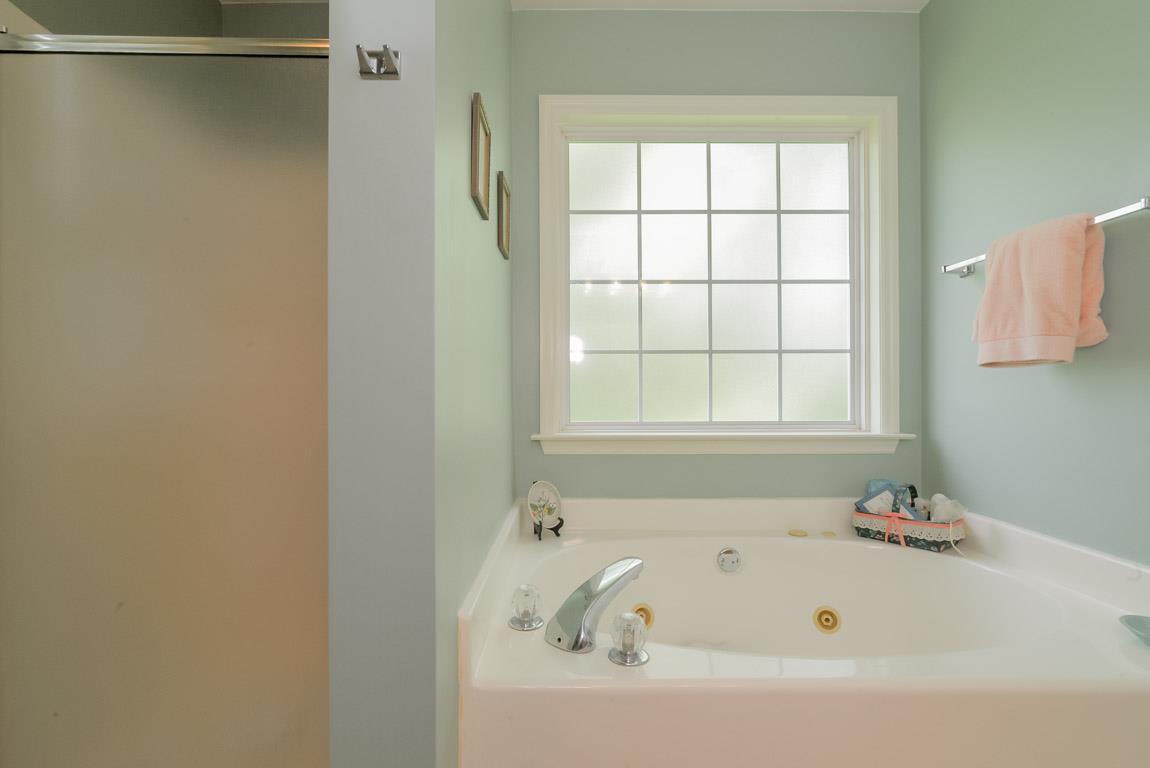 3387 Mahlon Moore Road Spring Hill, TN 37174 - Photo 20 of 29 a white bath tub sitting next to a window