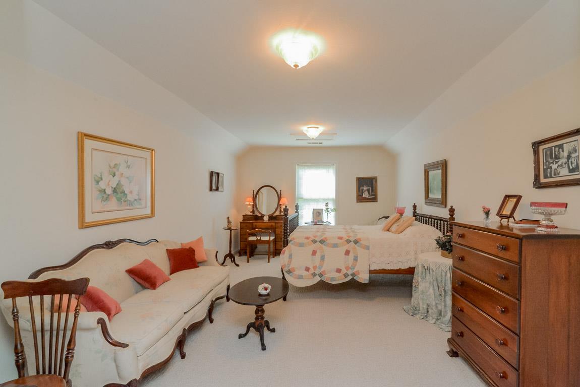 3387 Mahlon Moore Road Spring Hill, TN 37174 - Photo 21 of 29 a bed room with furniture and a lamp