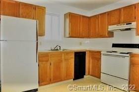 a kitchen with a refrigerator and a sink