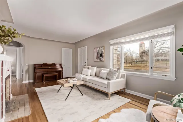 a living room with furniture a rug and a large window