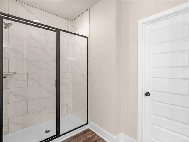 a bathroom with a glass shower door