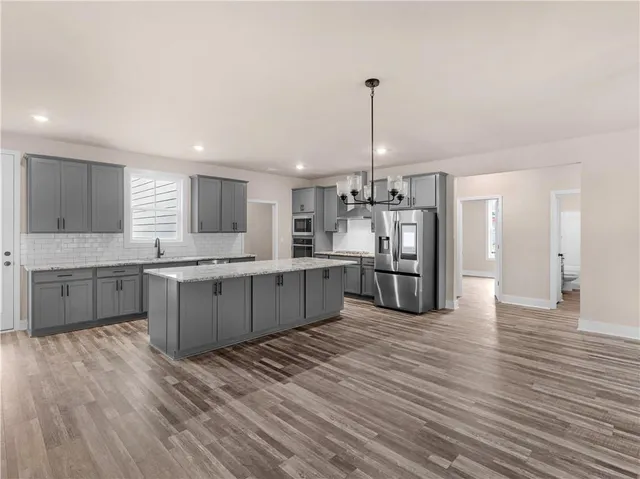 a large kitchen with a lot of counter space and stainless steel appliances