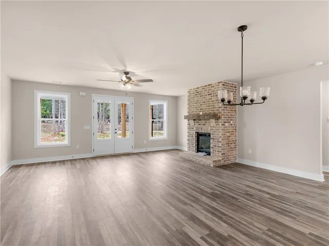 a view of a livingroom with wooden floor and a ceiling fan