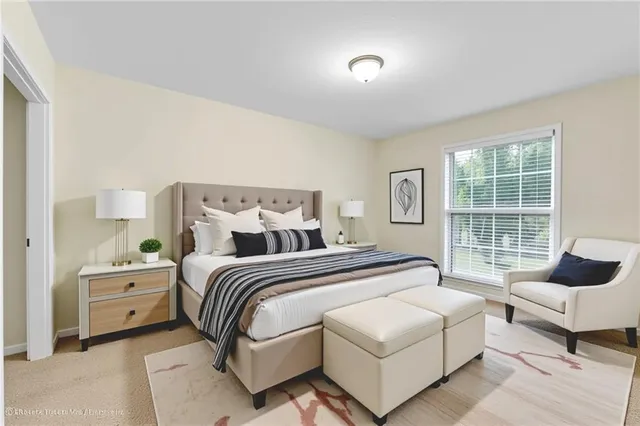 a spacious bedroom with a bed and a couch