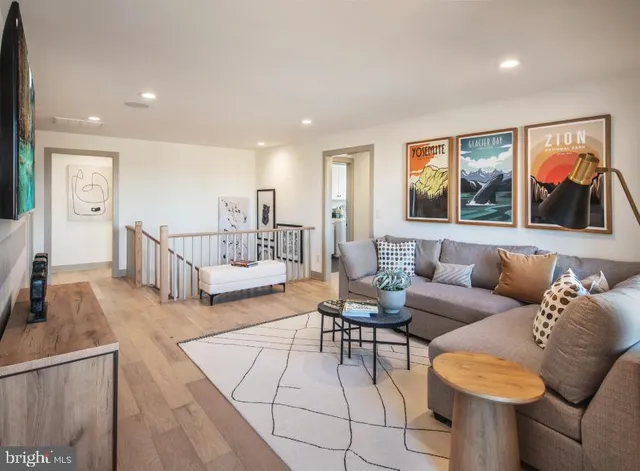 a living room with furniture and wooden floor
