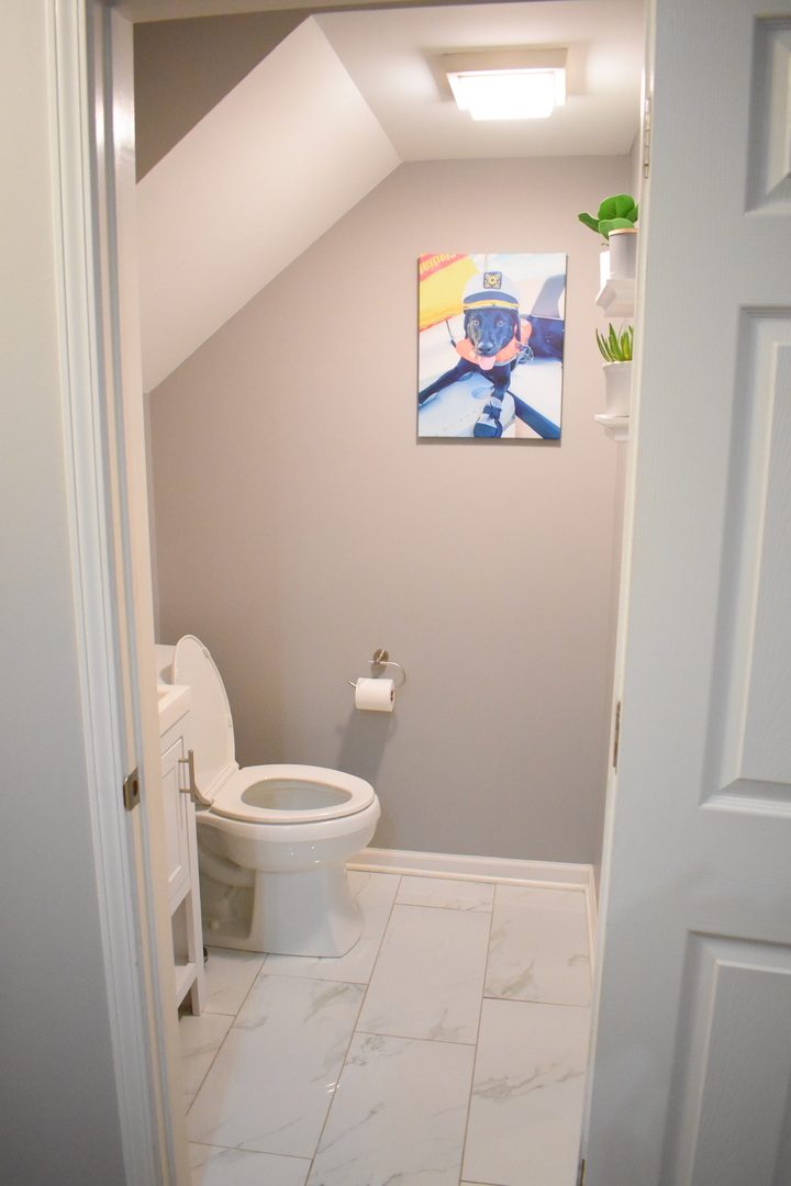 2851 North Southport Avenue, Unit A Chicago, IL 60657 - Photo 6 of 12 a white toilet sitting next to a bathroom sink and vanity