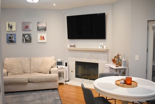 2851 North Southport Avenue, Unit A Chicago, IL 60657 - Photo 9 of 12 a living room with furniture and a fireplace