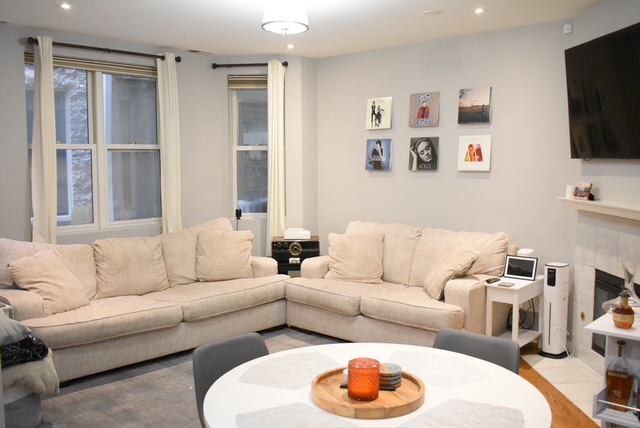 2851 North Southport Avenue, Unit A Chicago, IL 60657 - Photo 10 of 12 a living room with furniture and a flat screen tv