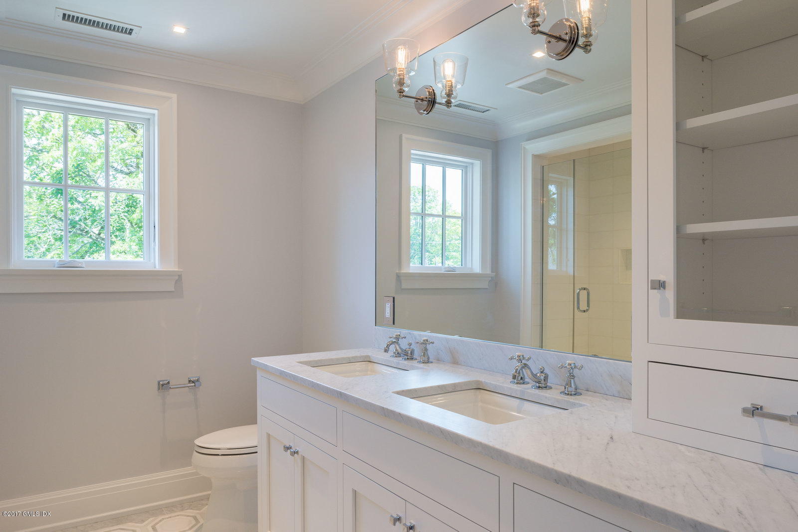 111 Mason Street, Unit 2A Greenwich, CT 06830 - Photo 11 of 18 a bathroom with a granite countertop sink a toilet and a mirror