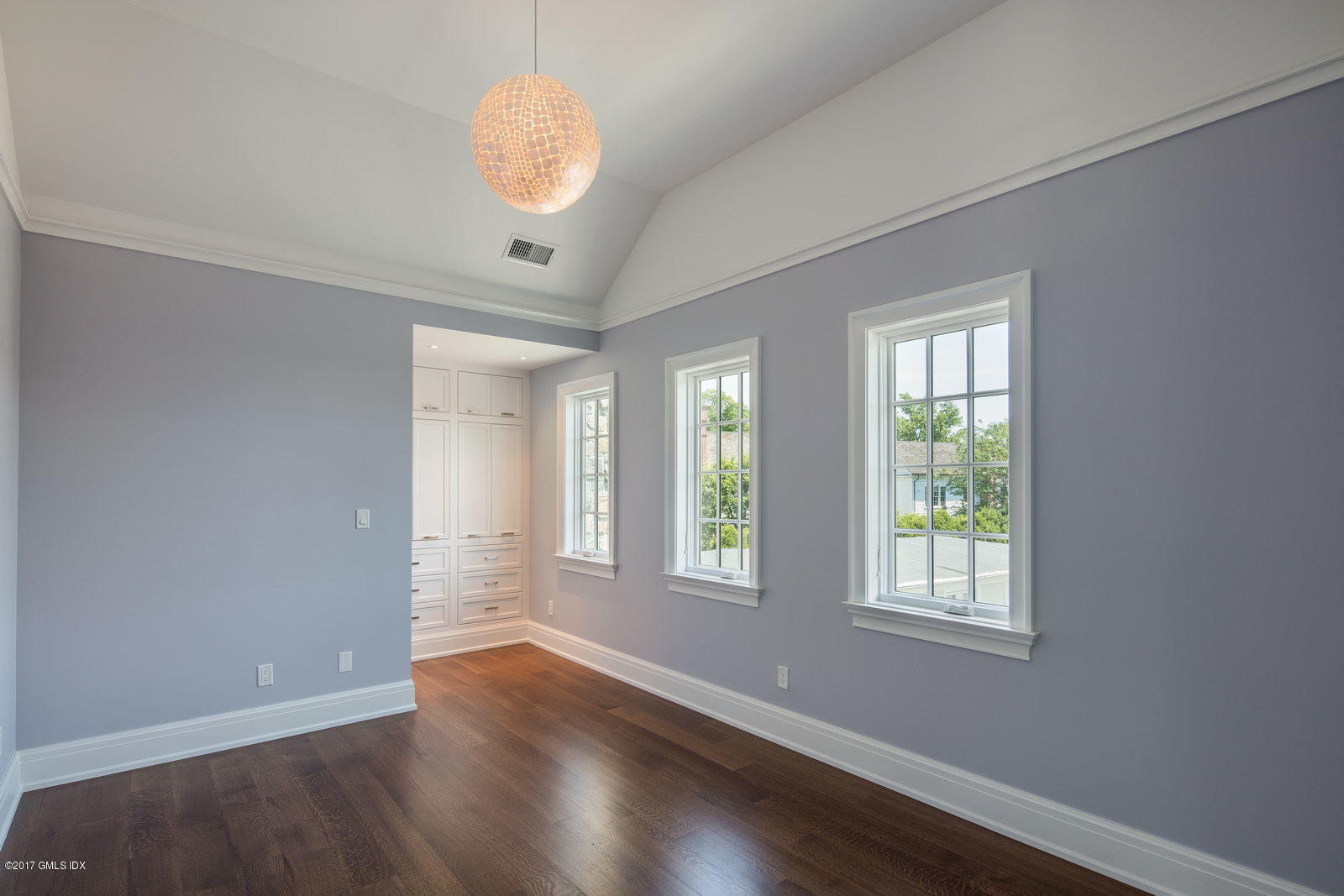 111 Mason Street, Unit 2A Greenwich, CT 06830 - Photo 12 of 18 an empty room with wooden floor and windows