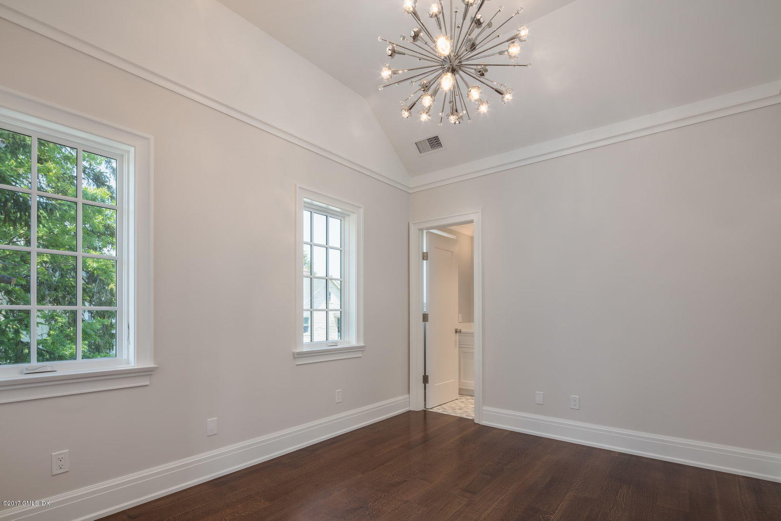 111 Mason Street, Unit 2A Greenwich, CT 06830 - Photo 14 of 18 an empty room with wooden floor fan and windows