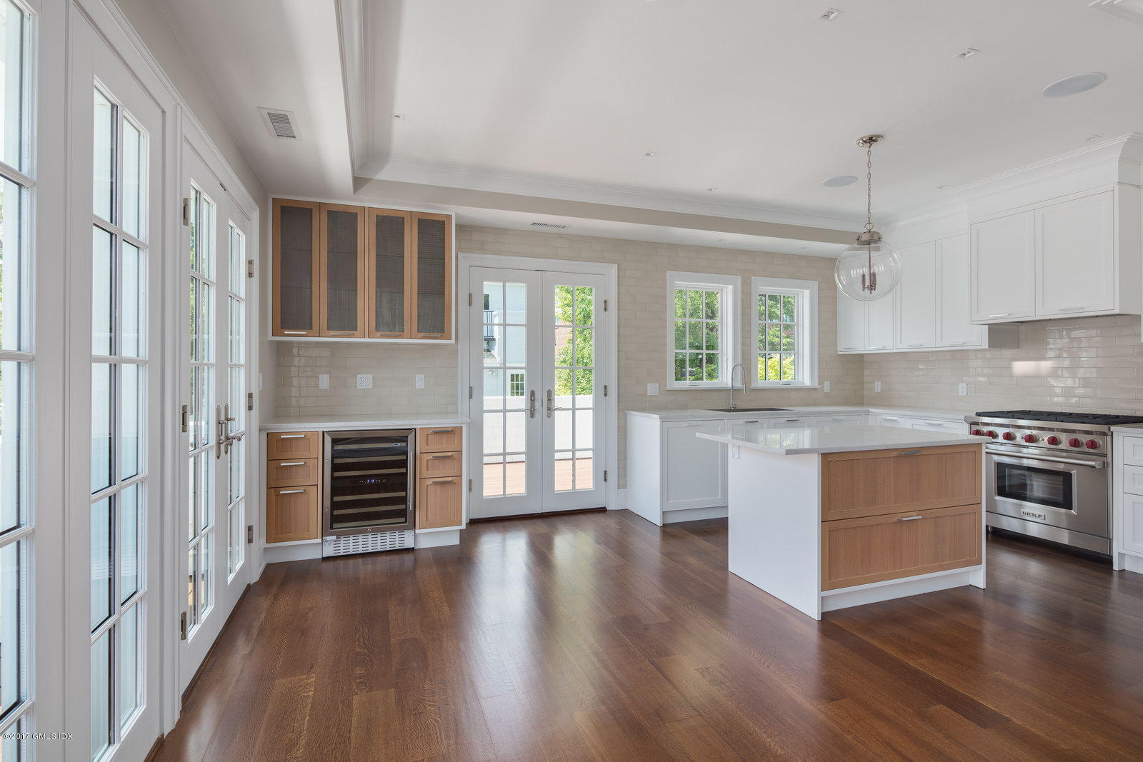 111 Mason Street, Unit 2A Greenwich, CT 06830 - Photo 2 of 18 a kitchen with granite countertop stainless steel appliances and wooden floor