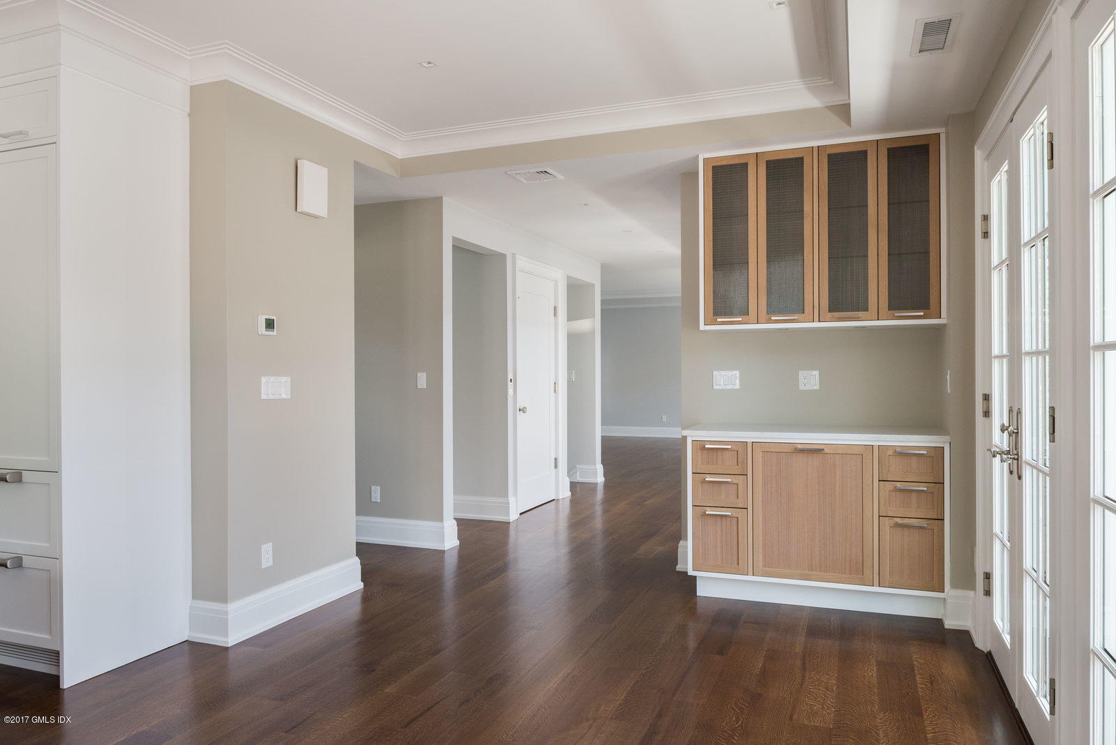 111 Mason Street, Unit 2A Greenwich, CT 06830 - Photo 5 of 18 a hallway with wooden floors and cabinet
