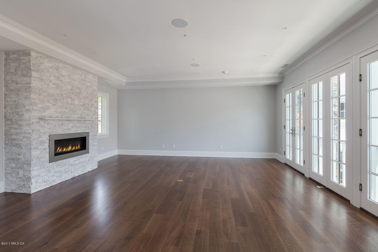 111 Mason Street, Unit 2A Greenwich, CT 06830 - Photo 6 of 18 a view of an empty room with wooden floor and a window