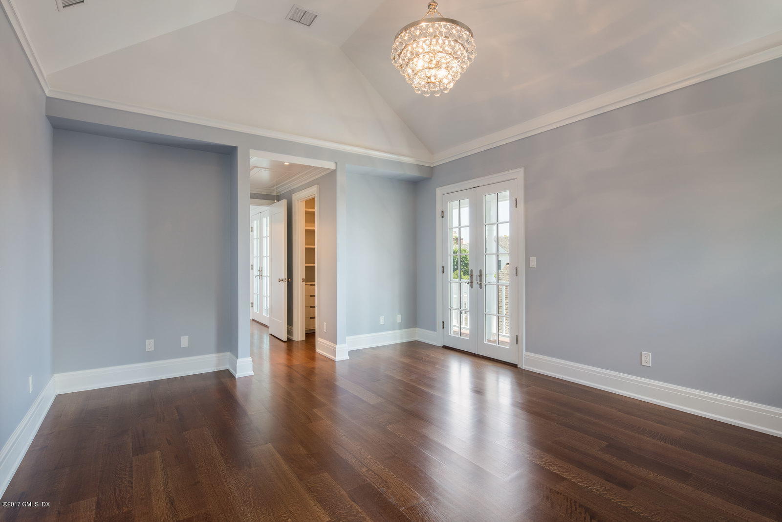 111 Mason Street, Unit 2A Greenwich, CT 06830 - Photo 9 of 18 an empty room with wooden floor and windows