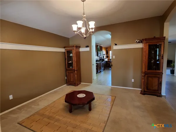 a view of a livingroom with furniture and chandelier