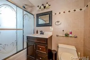 a bathroom with a toilet a sink and a mirror