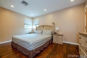 252-14 82nd Road Queens, NY 11426 - Photo 8 of 14 a bedroom with a bed and a dresser