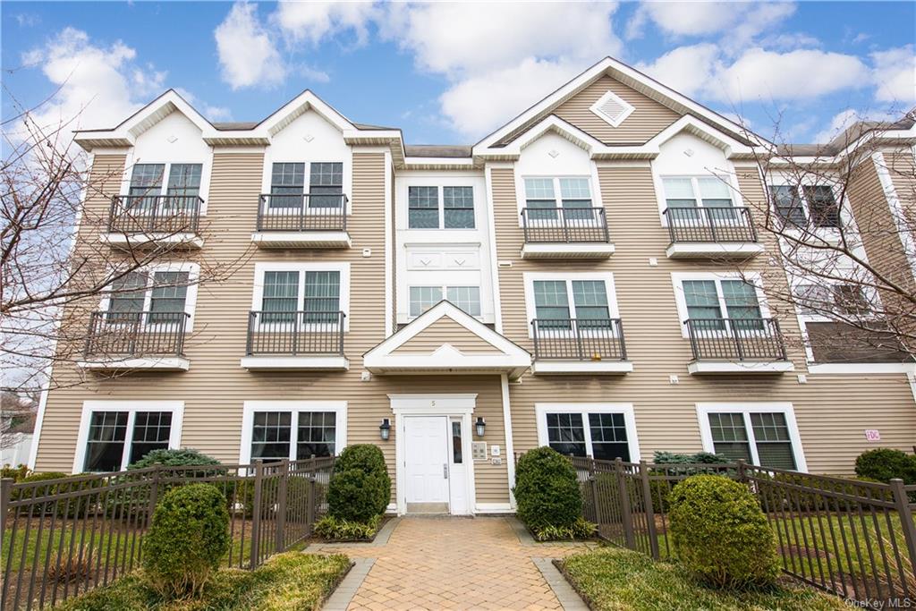 5 Minerva Place, Unit 1B White Plains, NY 10601 - Photo 1 of 1 a view of a brick building next to a yard