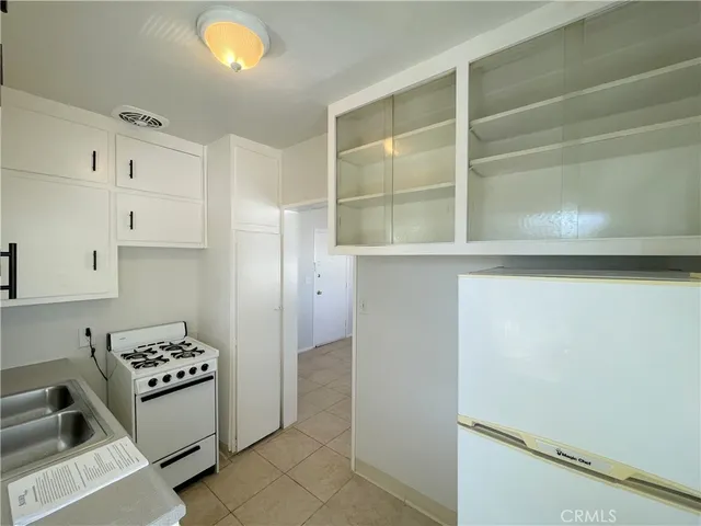 a kitchen with stainless steel appliances a refrigerator and a stove top oven