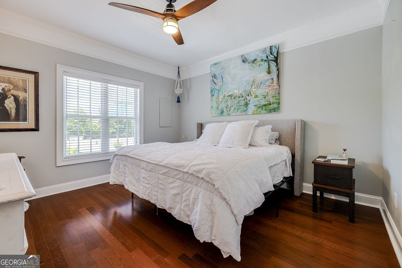 7272 Shellman Bluff Road Northeast, Unit 18 Townsend, GA 31331 - Photo 24 of 31 a bedroom with a bed and wooden floor
