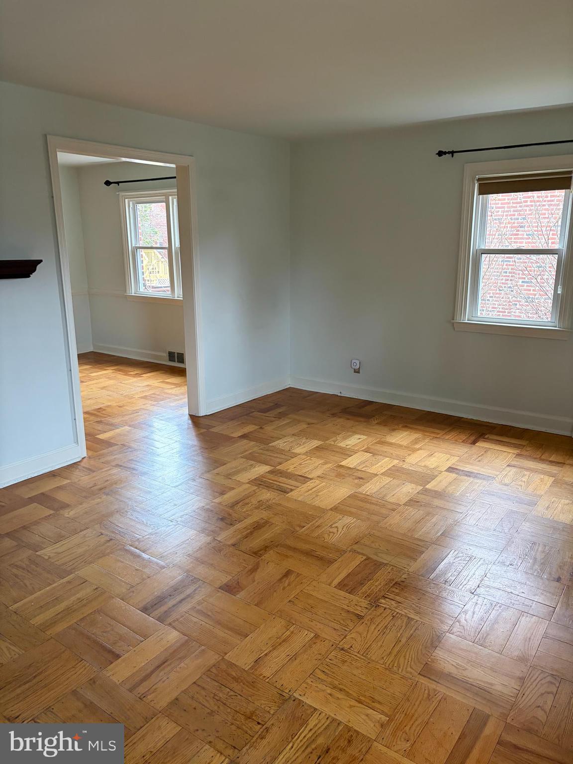 121 Rockglen Road Wynnewood, PA 19096 - Photo 4 of 13 an empty room with wooden floor and windows