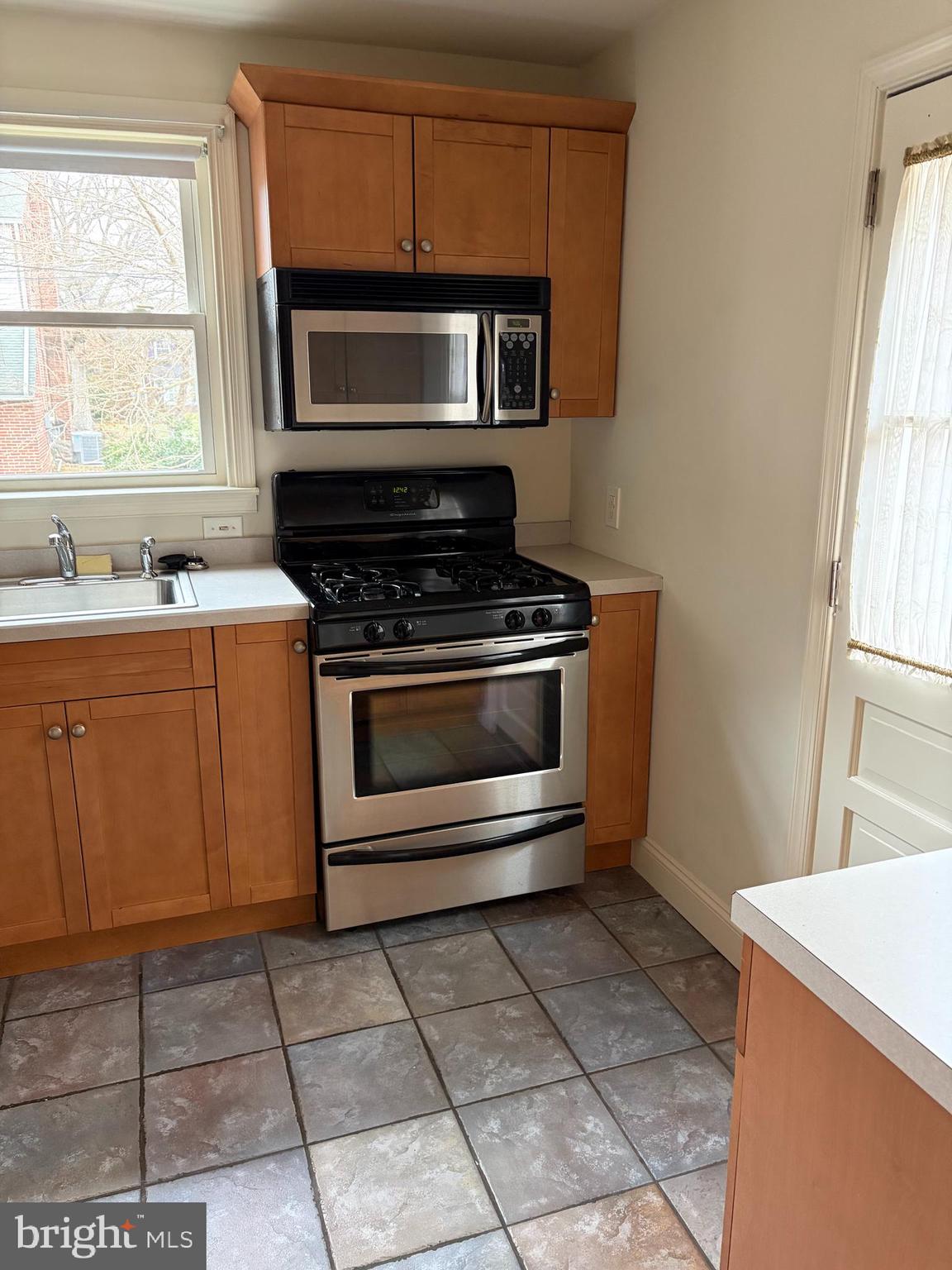 121 Rockglen Road Wynnewood, PA 19096 - Photo 5 of 13 a kitchen with a stove top oven cabinets and a window