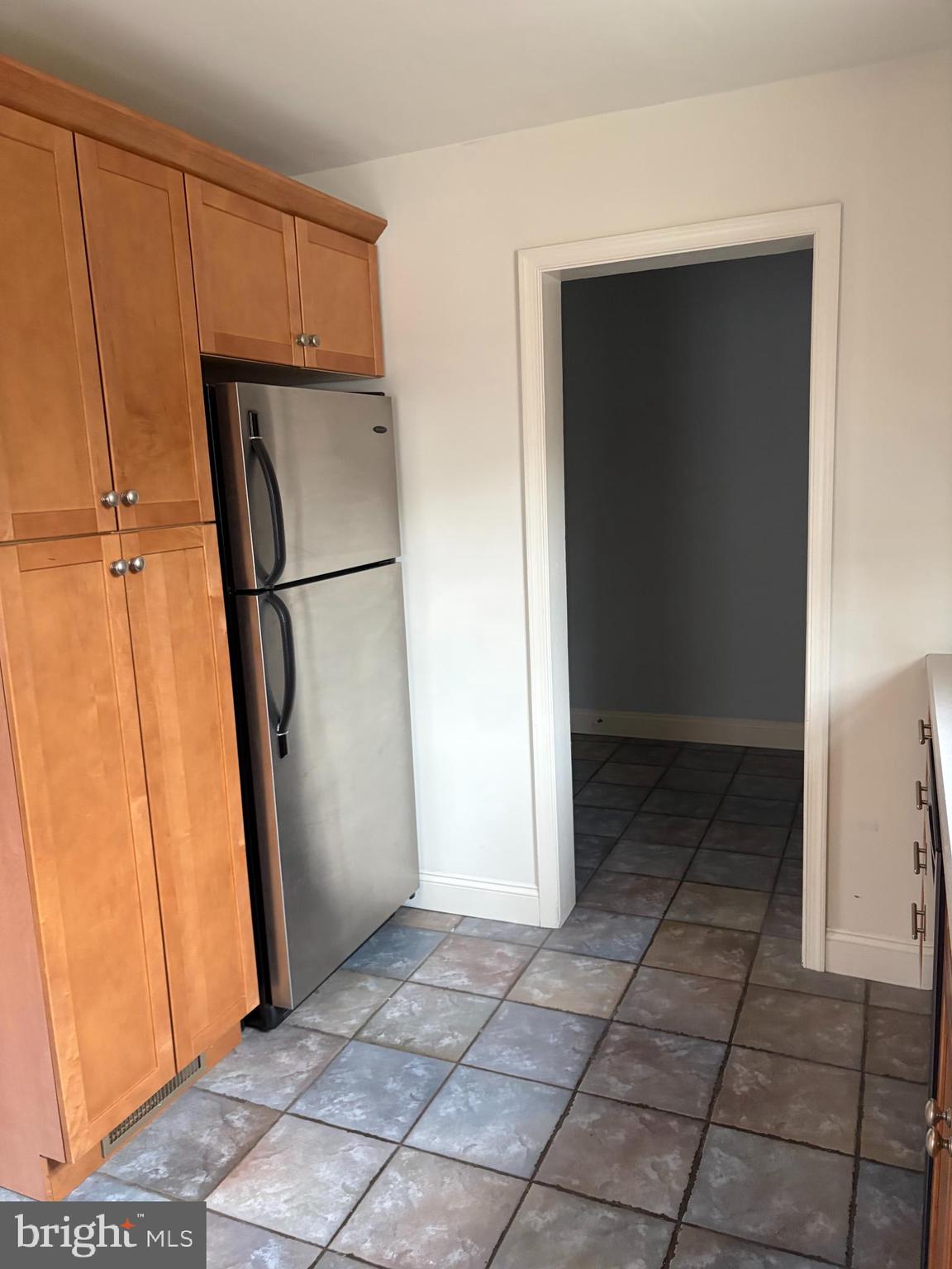 121 Rockglen Road Wynnewood, PA 19096 - Photo 6 of 13 a view of a refrigerator in kitchen and an empty room