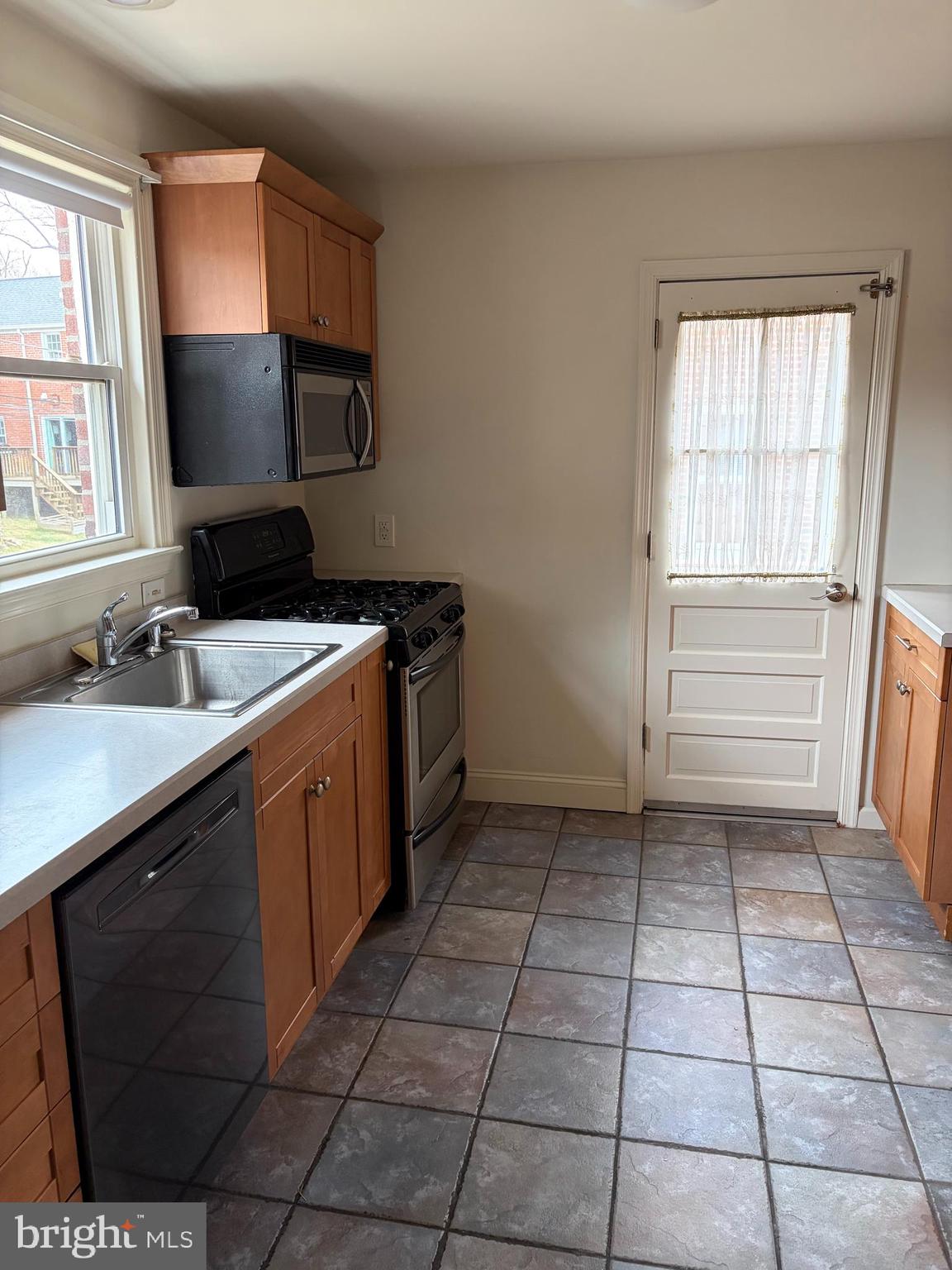 121 Rockglen Road Wynnewood, PA 19096 - Photo 7 of 13 a kitchen with a sink a stove cabinets and a window