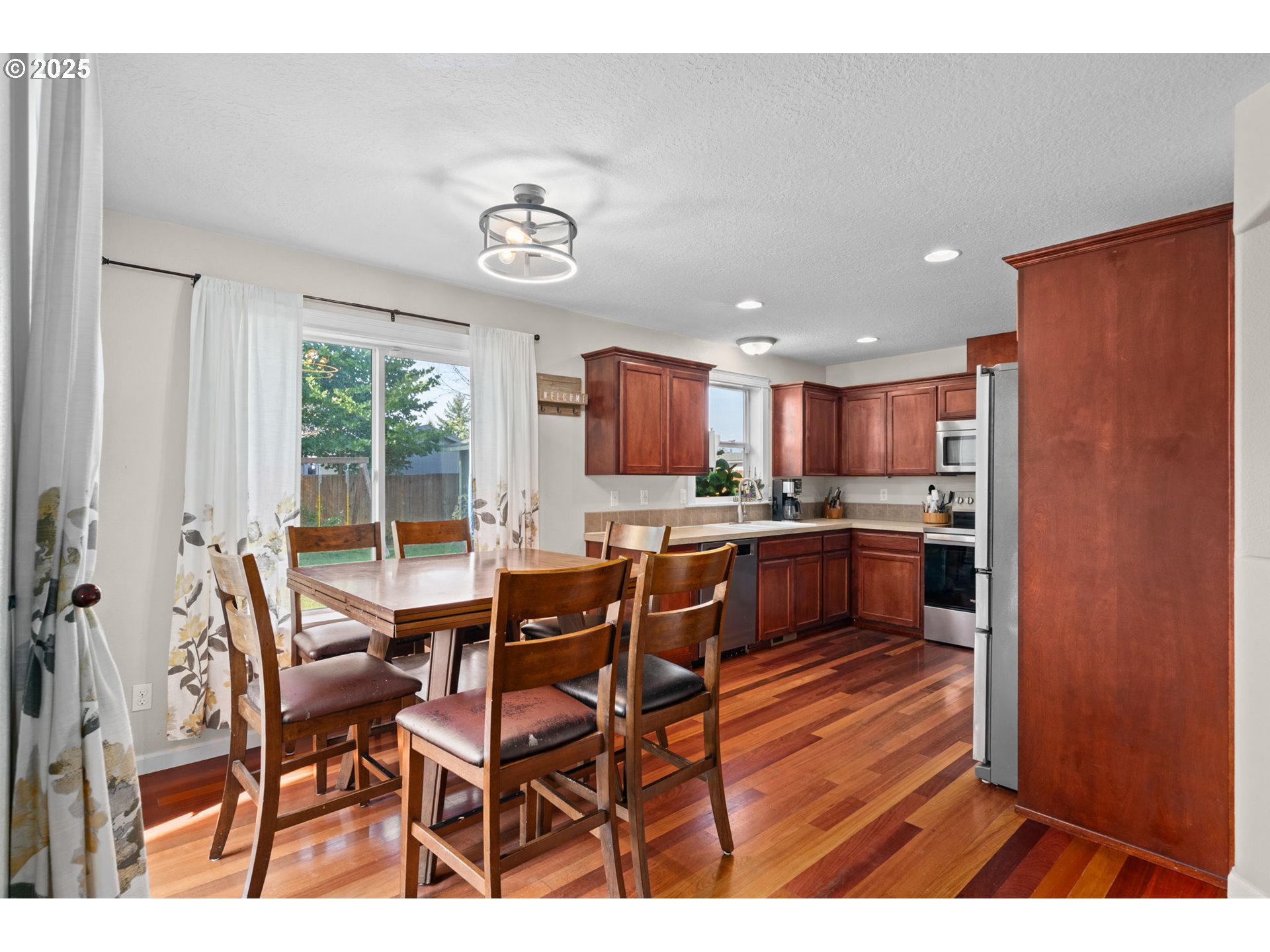 720 East Azalea Street Yamhill, OR 97148 - Photo 11 of 48 a kitchen with a table chairs refrigerator and cabinets