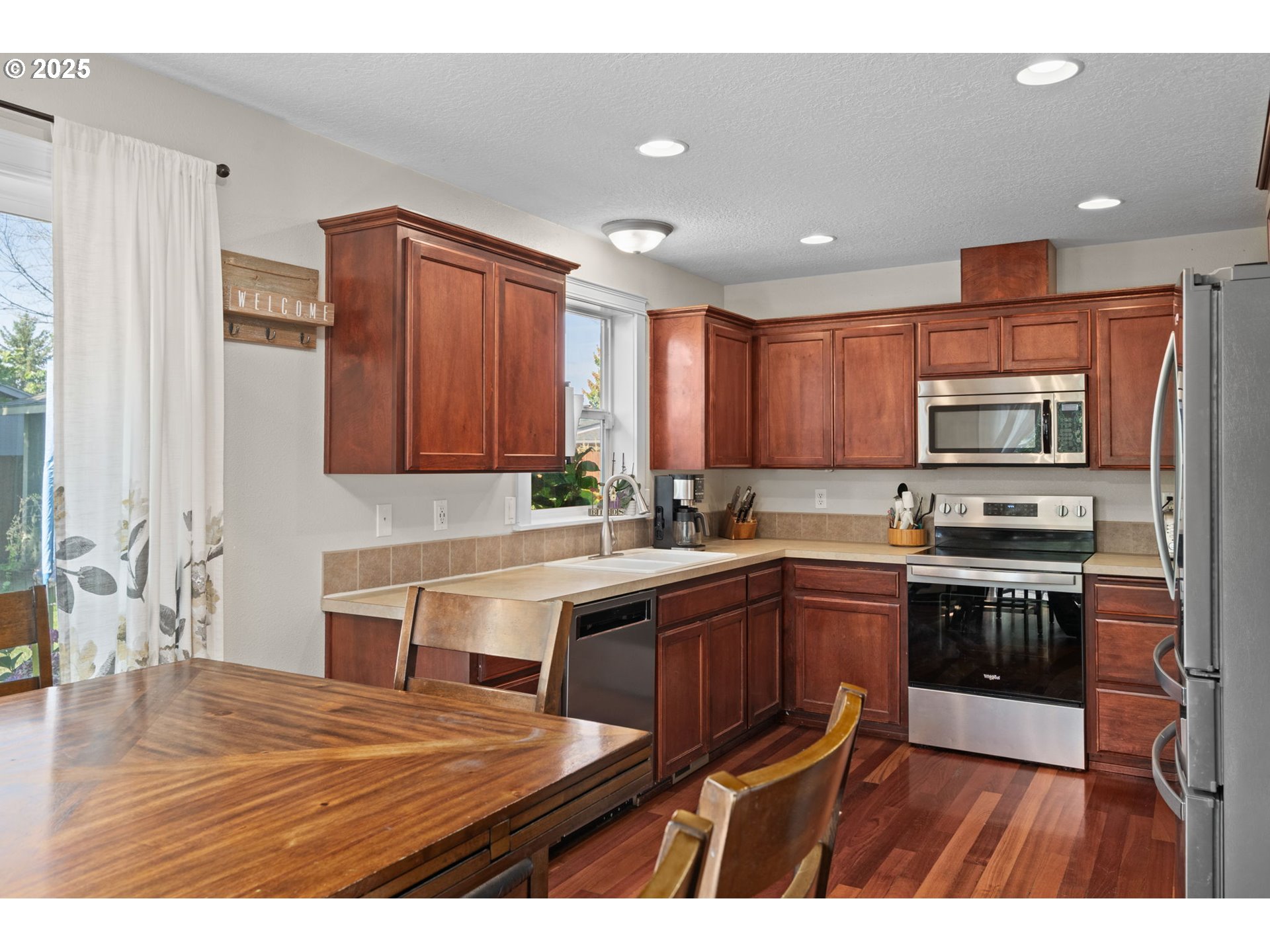 720 East Azalea Street Yamhill, OR 97148 - Photo 12 of 48 a kitchen with stainless steel appliances granite countertop wooden cabinets a sink dishwasher a stove and a refrigerator with wooden floor
