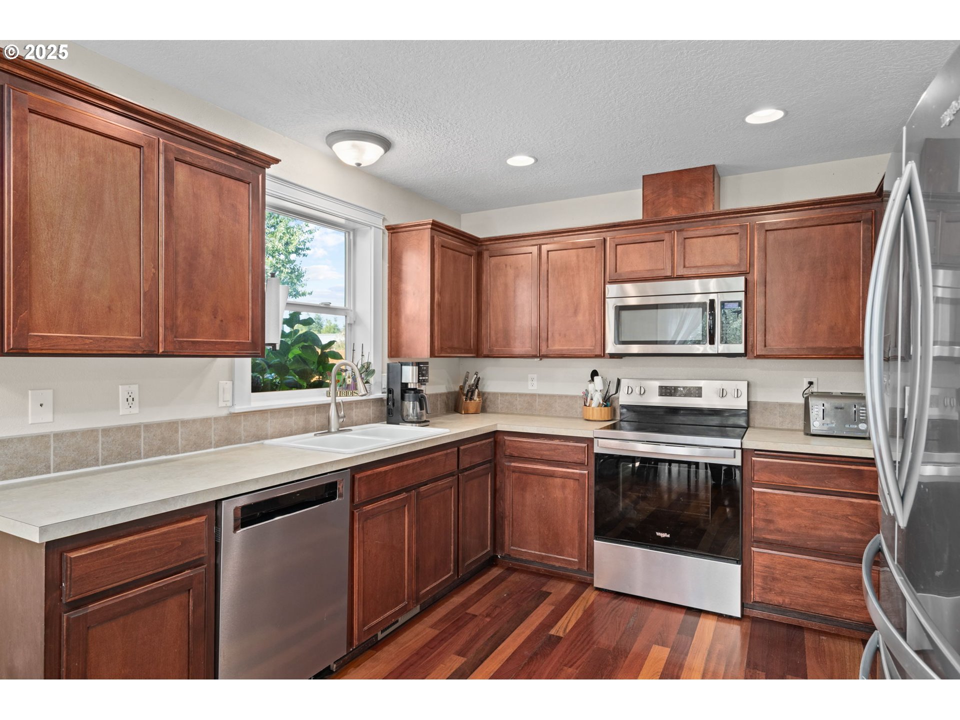 720 East Azalea Street Yamhill, OR 97148 - Photo 14 of 48 a kitchen with stainless steel appliances granite countertop a sink stove and microwave