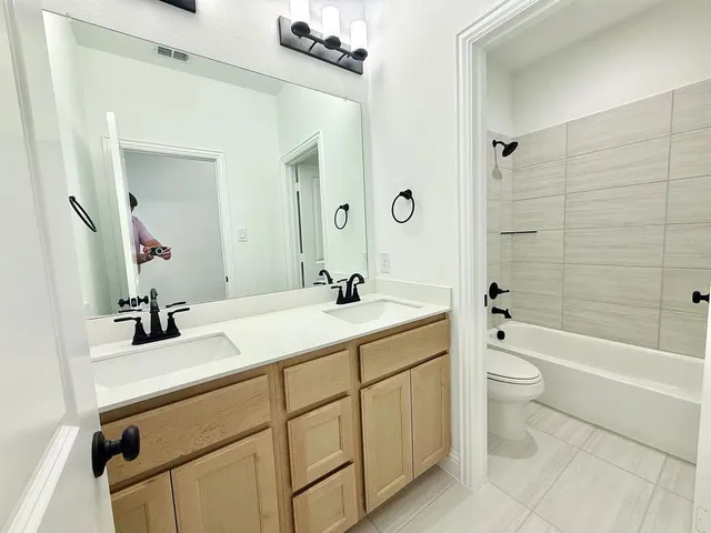 an empty room with a cabinet and mirror