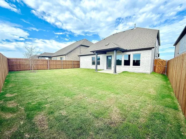 a view of a house with a yard and sitting area