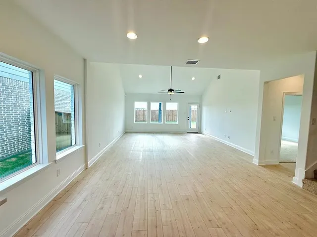 a view of an empty room and glass door