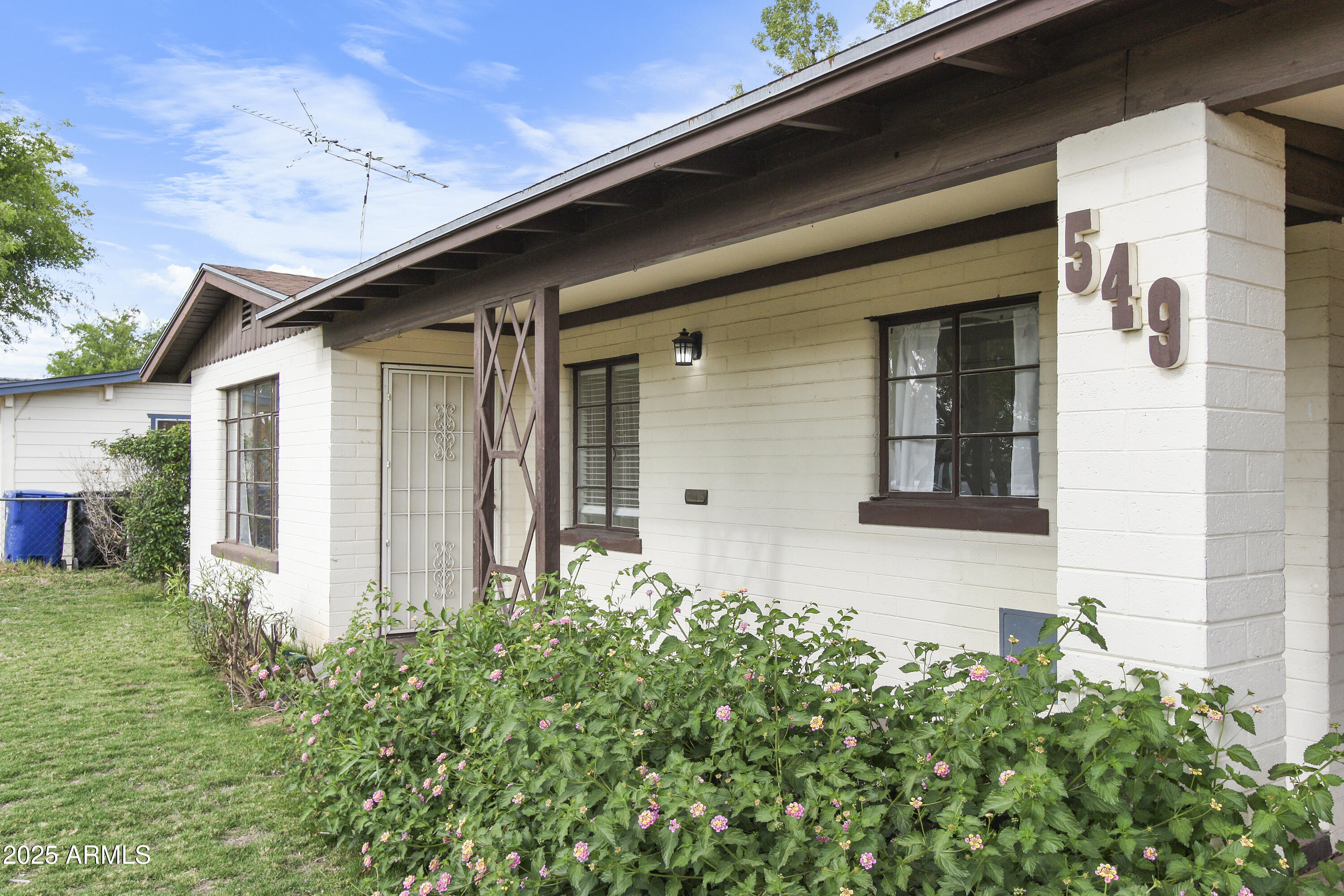 a front view of a house with garden