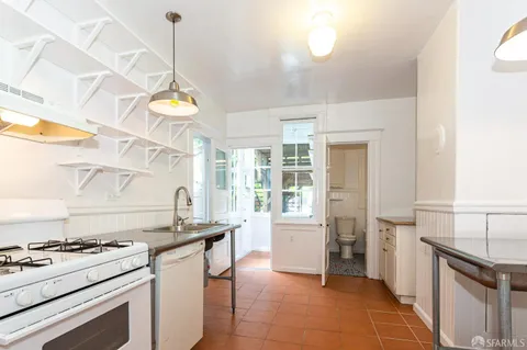 a kitchen that has a stove and a sink