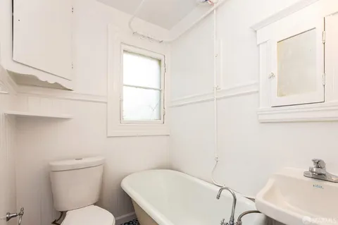 a white toilet sitting next to a bathroom sink