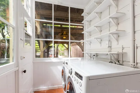 a utility room with a window and washer