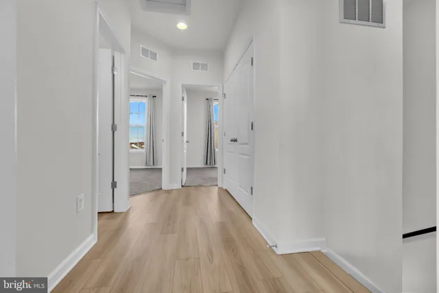 a view of an empty room with closet and bathroom