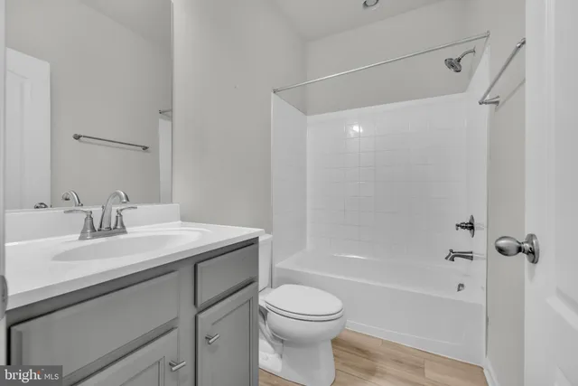 a bathroom with a shower a toilet and sink