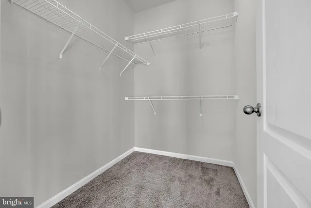 a picture of a bench in front of a wall