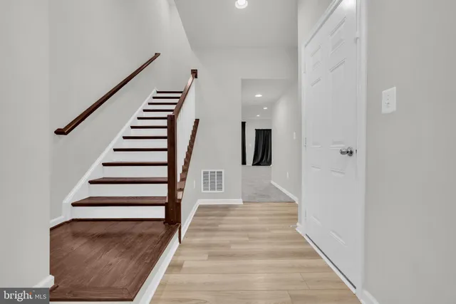 a view of entryway and hall with wooden floor
